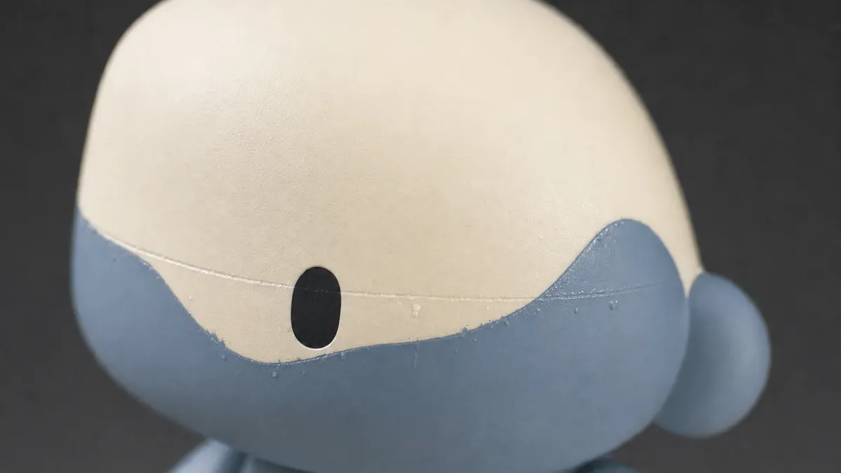 The same detail with typical replica flaws: crooked stitching, glue residue, rough edges